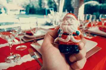 person holding santa claus figurine